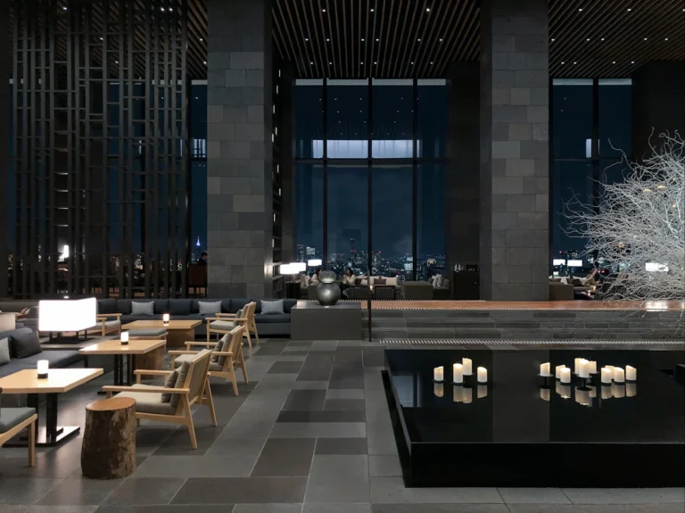 Spacious hotel lobby with tall windows and seating areas