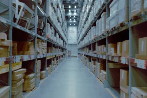 Warehouse storage aisles with tall shelving and stacked goods