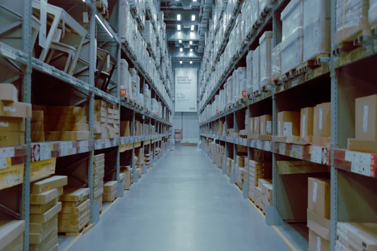 Warehouse storage aisles with tall shelving and stacked goods