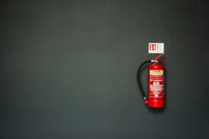 Red fire extinguisher mounted on a wall